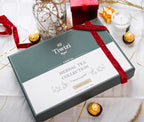 A closed luxury Tiwizi premium herbal tea gift box wrapped with a red ribbon